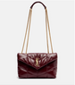 Burgundy handbag with gold chain strap on a white background