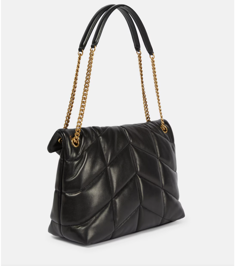 Black quilted handbag with gold chain strap on a white background