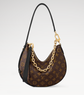 Designer handbag with monogram pattern and gold chain detail on a white background