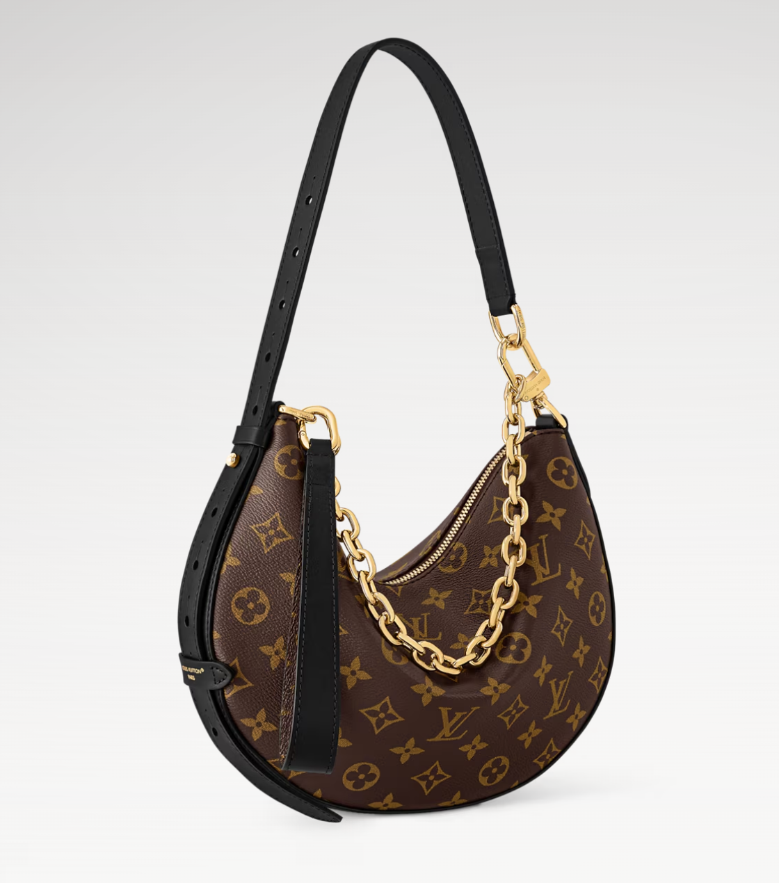 Designer handbag with monogram pattern and gold chain detail on a light gray background