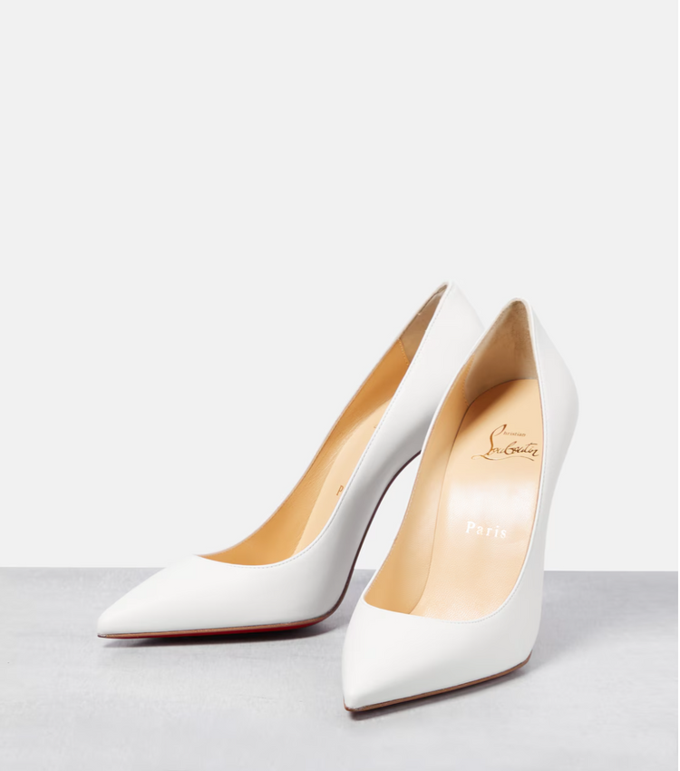 White high-heeled shoes on a light gray background