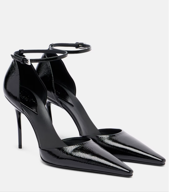 Black high-heeled shoes with ankle straps on a white background