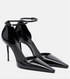 Black high-heeled shoes with ankle straps on a white background