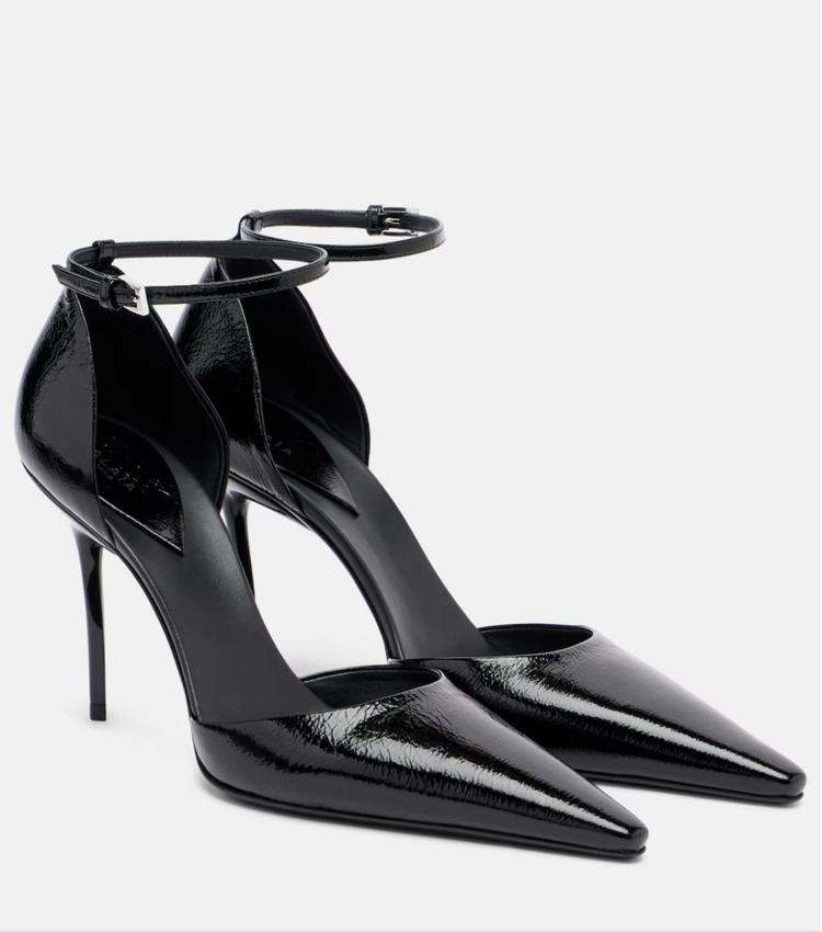 Black high-heeled shoes with ankle straps on a white background