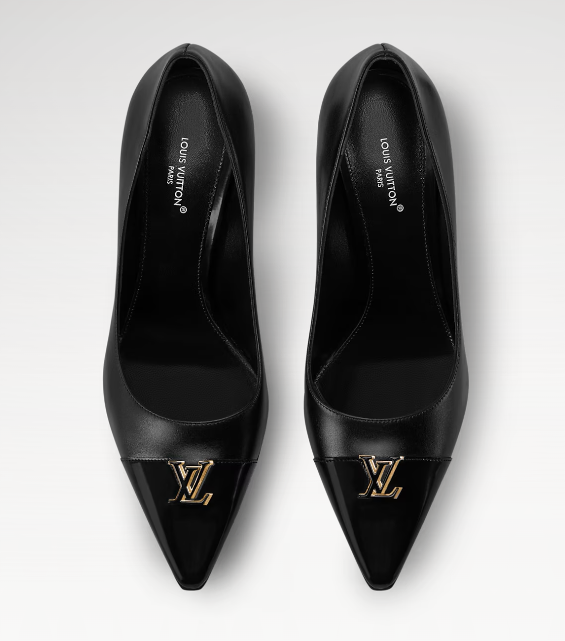 Pair of black high-heeled shoes with gold Louis Vuitton logo on a white background