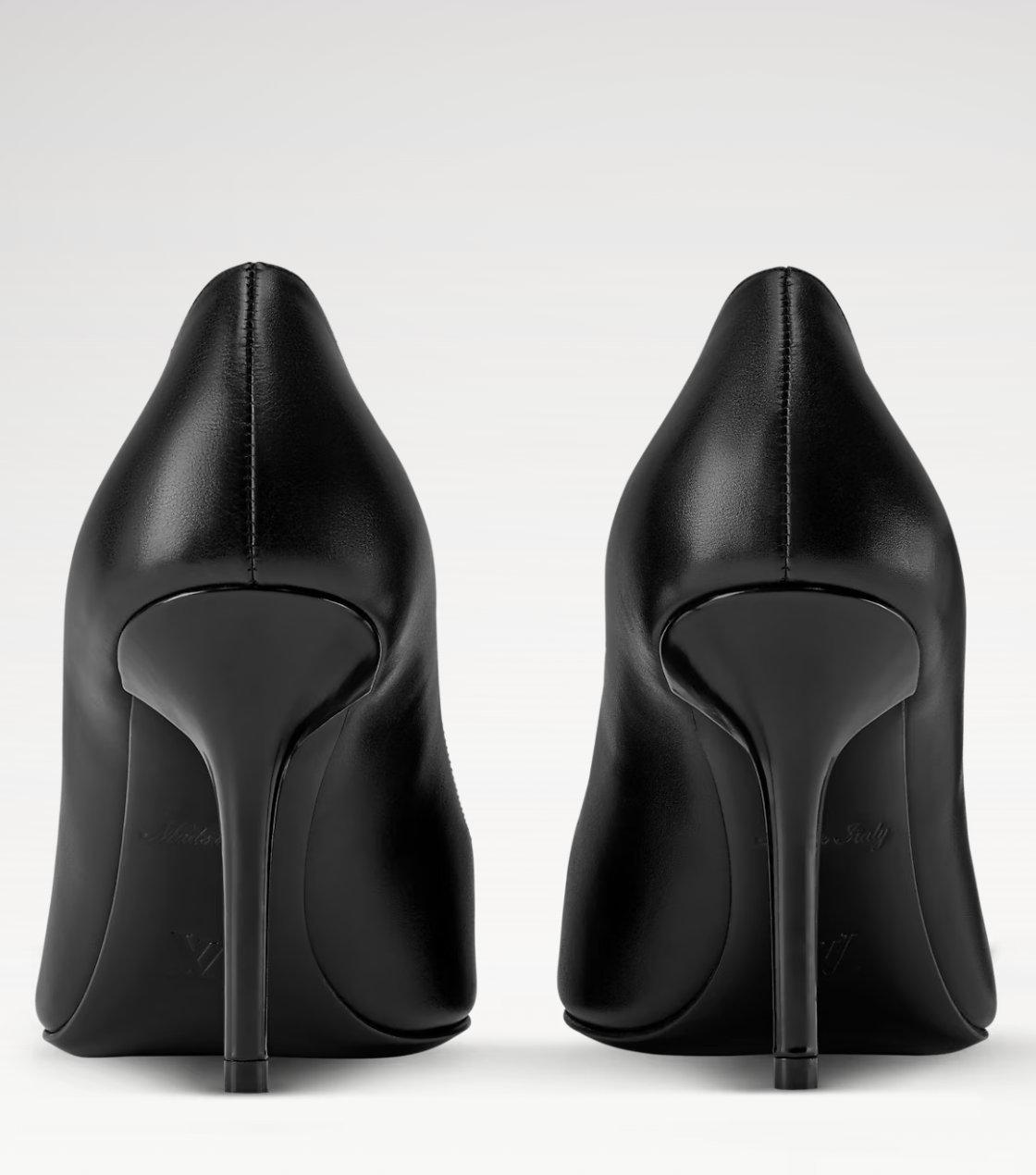Pair of black high-heeled shoes on a white background