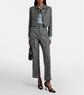 Woman wearing a gray suit with a white background