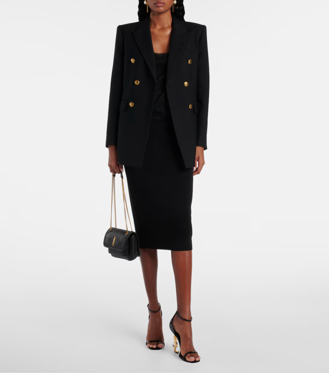 Person wearing a black double-breasted blazer and skirt set on a white background