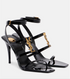 YSL Black high-heeled sandals with gold accents on a white background