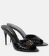 Black high-heeled sandals with gold accents on a white background