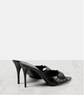 Black high-heeled shoes on a light gray background