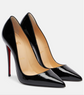 Black high-heeled shoes with red soles on a white background