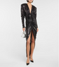 Black sequin dress with a high slit on a white background