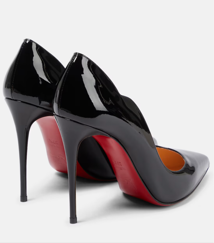 Black high-heeled shoes with red soles on a white background