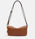 Brown leather handbag with a strap on a light gray background