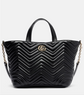 Black quilted handbag with a brand logo on a light gray background
