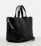 Black quilted handbag with a gold chain on a white background