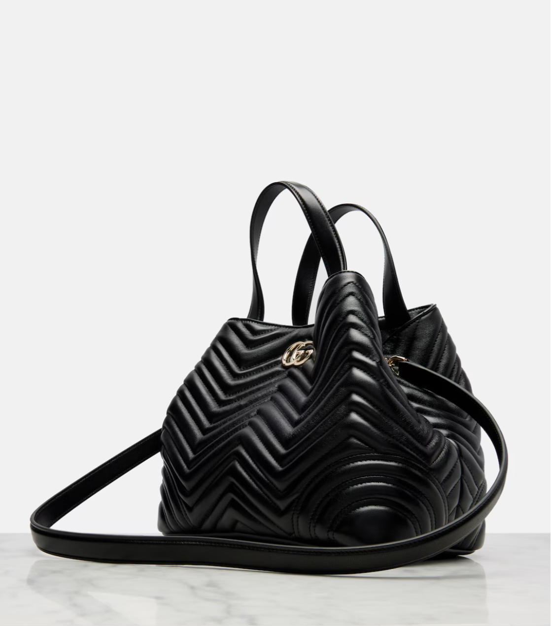 Black quilted handbag with a brand logo on a white background