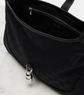 Black textured bag with a keychain on a light gray background