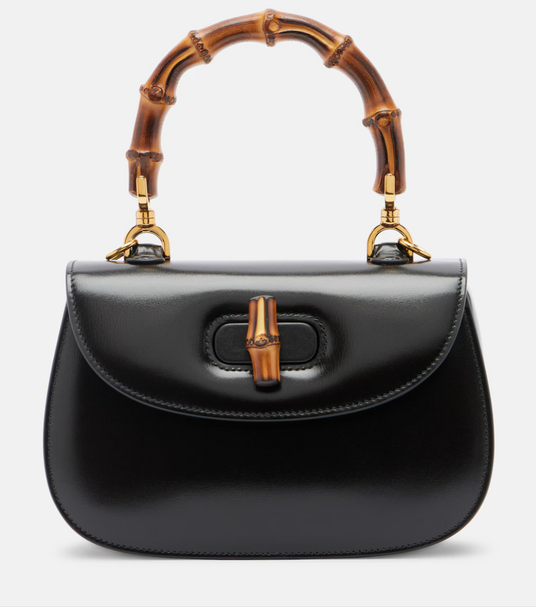 Black handbag with bamboo handle on a white background